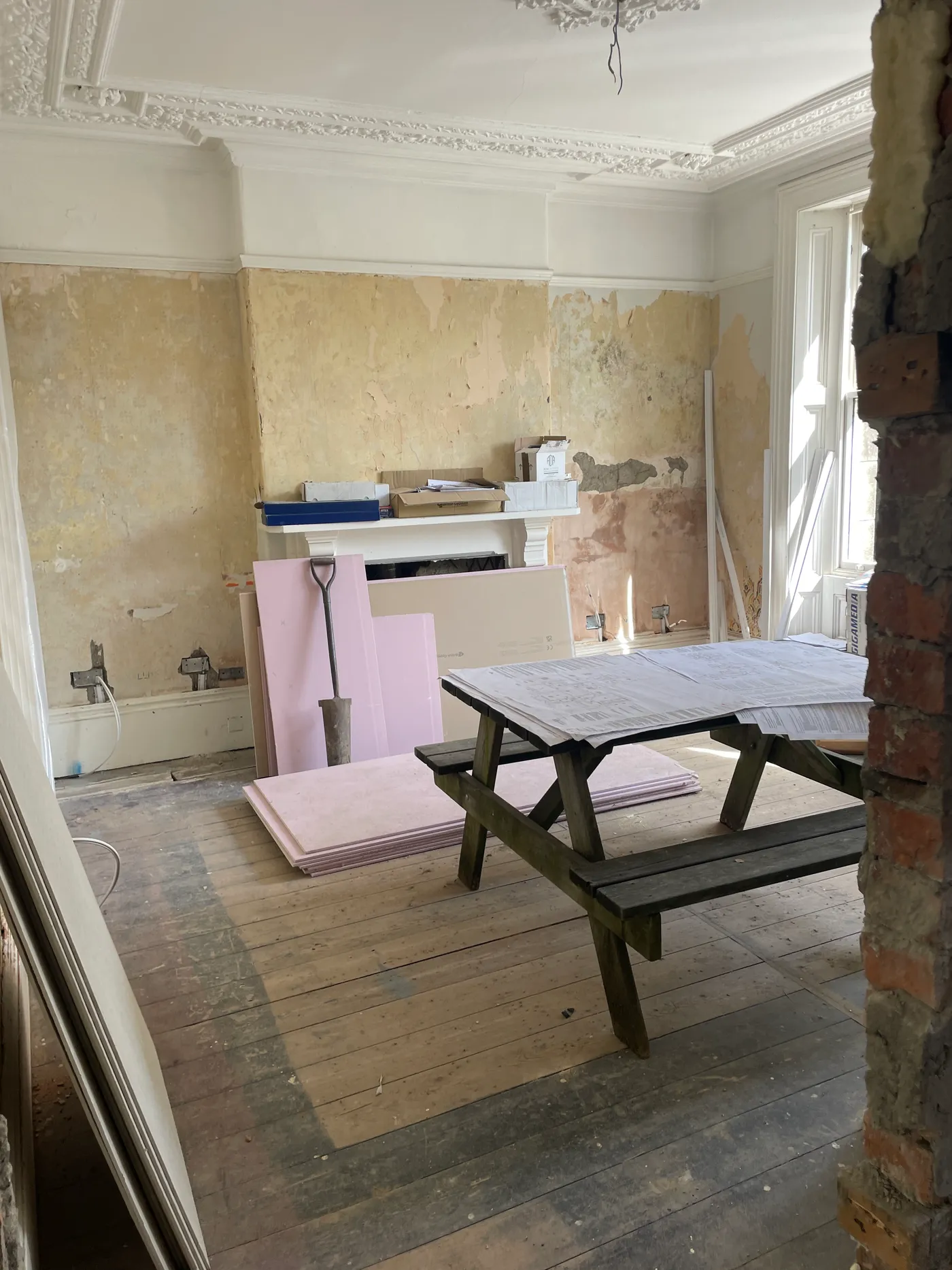A room at Base Camp Hathersage stripped back to bare plaster and floorboards