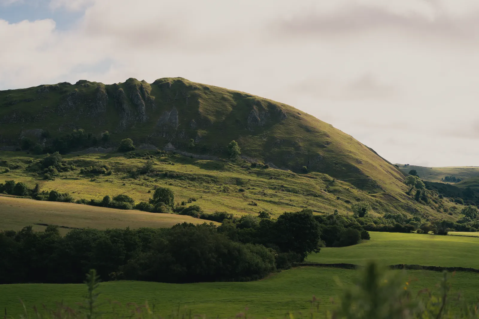 Win Hill rising above the reservoir and the valley pastures